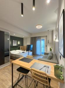 a living room with a table and a bed at TWO ENTIRE APARTMENTS LIV Luxury Central C-D in Thessaloniki