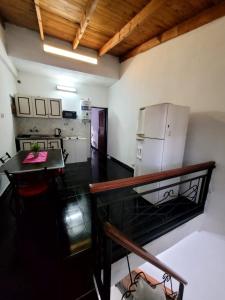 a kitchen with a refrigerator and a table in a room at Zurita Apart in San Fernando del Valle de Catamarca +14 photos