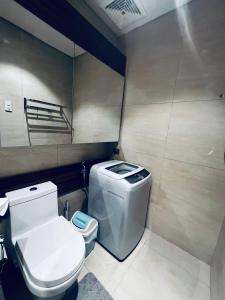 a small bathroom with a toilet and a sink at Seaside serenity tambuli condo in Maribago