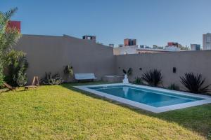 a swimming pool in the yard of a house at Chito House in Buenos Aires
