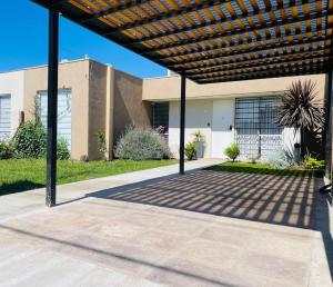 a pergola in front of a house at Chito House in Buenos Aires