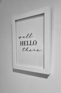a white picture frame hanging on a wall at Cosy Cottage in Harvington in Harvington