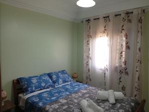 a bedroom with a bed with towels on it at appartement Airport Guests Marrakech in Marrakesh
