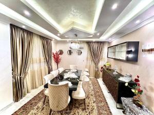 a dining room with a table and white chairs at Luxurious apartment in New cairo