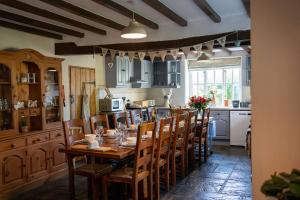a kitchen with a wooden table and chairs at Quarry House in Presteigne