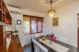 a kitchen with a table and chairs in a room at Apartments Ružić in Split +53 photos