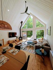 a living room with a couch and a table at Chalet au Mont-Édouard, Les 3 Versants 38B in LʼAnse-Saint-Jean