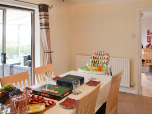 a dining room with a table with food on it at Hawthorne House in Amble