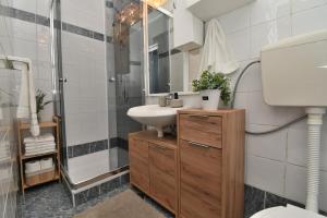 a bathroom with a sink and a shower at House Velebit by the sea in Stinica +33 photos