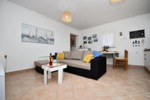 a living room with a couch and a table at House Velebit by the sea in Stinica