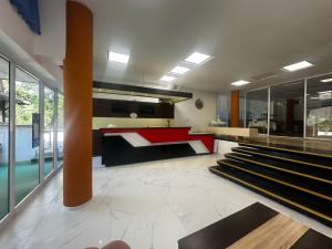 a kitchen with a red counter and some stairs at Hotel Tomis Neptun in Neptun