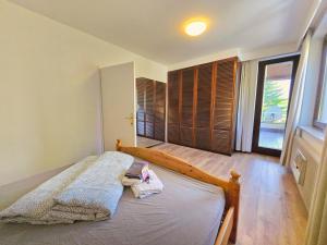 a bedroom with a bed and a large window at Innsbruck Nature & City House I Free Parking in Innsbruck