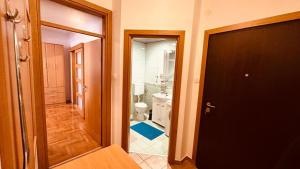 a bathroom with a toilet and a door to a room at Budva Summer House in Budva