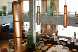 a lobby with couches and tables and a restaurant at Municipal Grand in Savannah