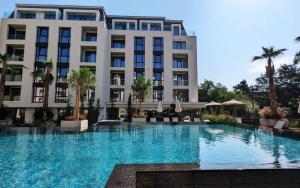 a large swimming pool in front of a building at Azur Pearl by RV Apartments in Saints Constantine and Helena
