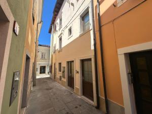an alley in an alley way between two buildings at Apartments Portéa - NEW 2025 in Izola