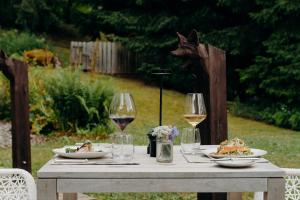 a table with glasses of wine and food on it at Les Chalets du Mont d'Arbois & Spa, Megève in Megève +84 photos