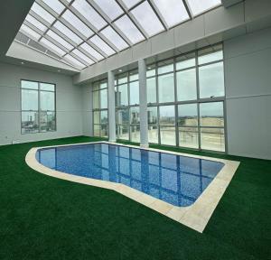 a swimming pool in a building with a glass ceiling at Villa Vergueiro Hotel in Passo Fundo +22 photos