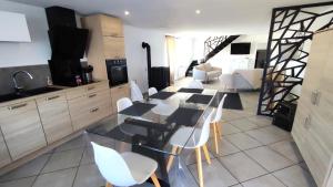 a kitchen with a table and white chairs in a room at Heidi in This