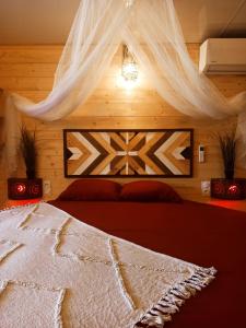a bedroom with a bed with a mosquito net at L'Idylle Moment de Détente in Nay +14 photos