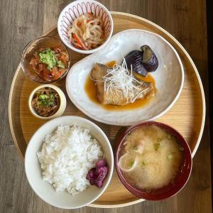a plate of food with rice and bowls of food at 古民家1棟貸し Kirikushi Coastal Village 自然に囲まれたのどかな島の宿 in Etajima