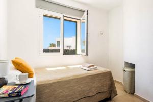 a bedroom with a bed with a large window at Villa Bini Mestral by Villa Plus in Binibeca +16 photos