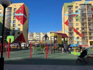a playground in the middle of a city with buildings at Квартира Люкс на Поділлі in Vinnytsya