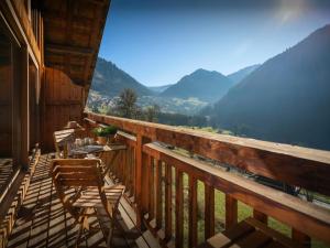 a balcony of a cabin with a view of mountains at Chalet Wanderlust - OVO Network in Châtel