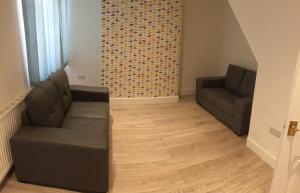 a living room with two couches and a wooden floor at Warm & Cozy 3-Bed Apartment at Kexgill in Middlesbrough