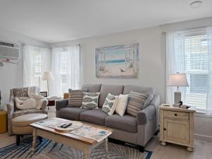 a living room with a couch and a table at Sweet Beach Retreat home in Wells