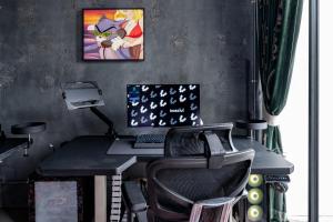 an office with a desk with a computer and a chair at Boss Level Gaming Hotel in Rawai Beach