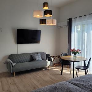a living room with a couch and a table at Neues Ruhrtal Apartment 3 mit Klimaanlage, Balkon in Wickede (Ruhr)