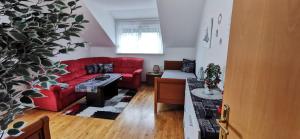 a living room with a red couch and a table at Lake View in Millstatt