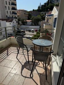 Ein Tisch und Stühle auf einem Balkon mit Aussicht in der Unterkunft Jadran Rafailovic in Rafailovici