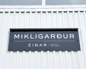 a sign on the side of a building at Eiðar - Hostel in Egilsstaðir