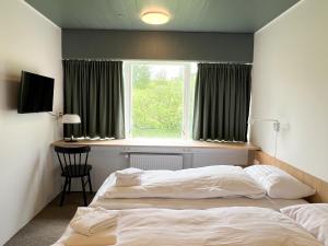 Voodi või voodid majutusasutuse Eiðar - Hostel toas +37 fotot