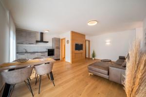 a living room with a couch and a table at 735 Apartment Julia I Villa Ehrenburg in Merano