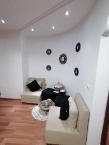 a living room with a couch and a table at Tout pour plaire à chacun in Tangier