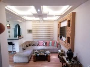 a living room with a couch and a table at Tout pour plaire à chacun in Tangier