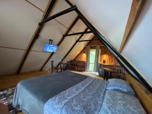 a bedroom in a tent with a bed and a tv at Cabanas na Montanha 2 in Campos do Jordão