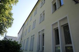 a white building with windows on the side of it at Art Rock Airport in Cologne