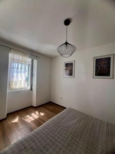 an empty bedroom with a bed and a window at Vranac Country house Šibenik in Donje Polje +40 photos