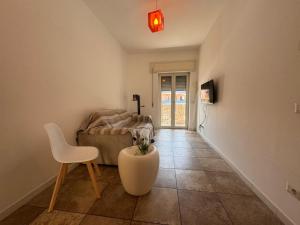 a living room with a couch and a table and a chair at CASA Degli ARTISTI in Acilia