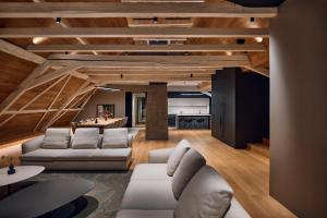 a living room with white furniture and wooden ceilings at Heritage Hotel Kurija Mihalović in FeriÄanci