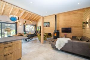 a living room with a couch and a fireplace at Simply Morzine - Chalet Stade in Morzine