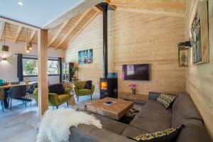 a living room with a couch and a table at Simply Morzine - Chalet Stade in Morzine +48 photos