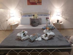 a bedroom with a bed with towels on it at Adelia's Luxury Studio in Corfu in Corfu