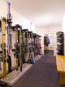 a bunch of skis are lined up in a room at Ajax Ski Club in Mount Buller