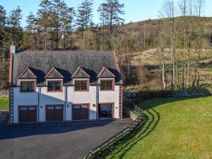 a large white house with a gray roof at Hill View at Kenmuir in Dalbeattie
