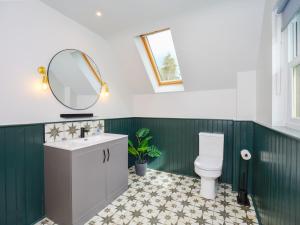 a bathroom with a toilet and a mirror at Hill View at Kenmuir in Dalbeattie +7 photos